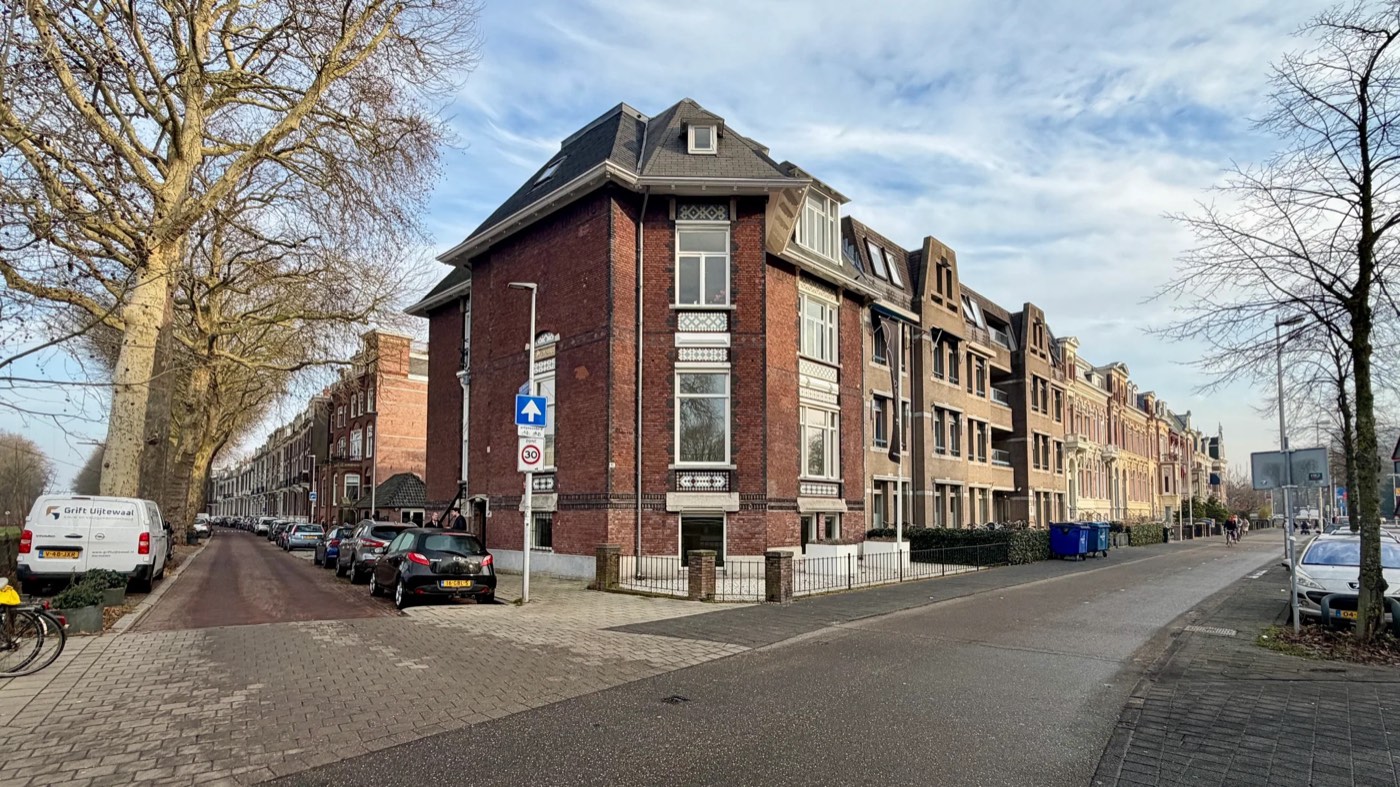 De monumentale bakstenen hoekgevel van Bilt 182 uit 1910, met hoge ramen en decoratief metselwerk